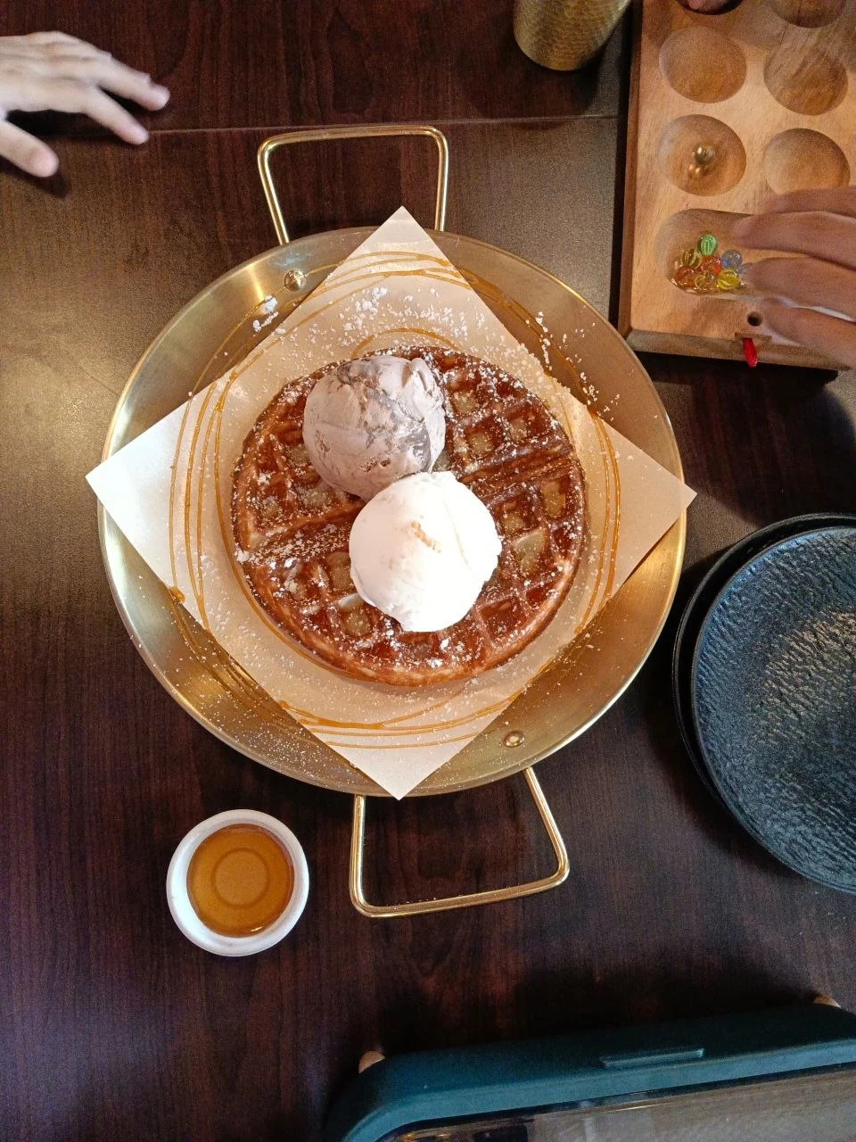 Waffle topped with two scoops of ice cream at Two of Six Café.